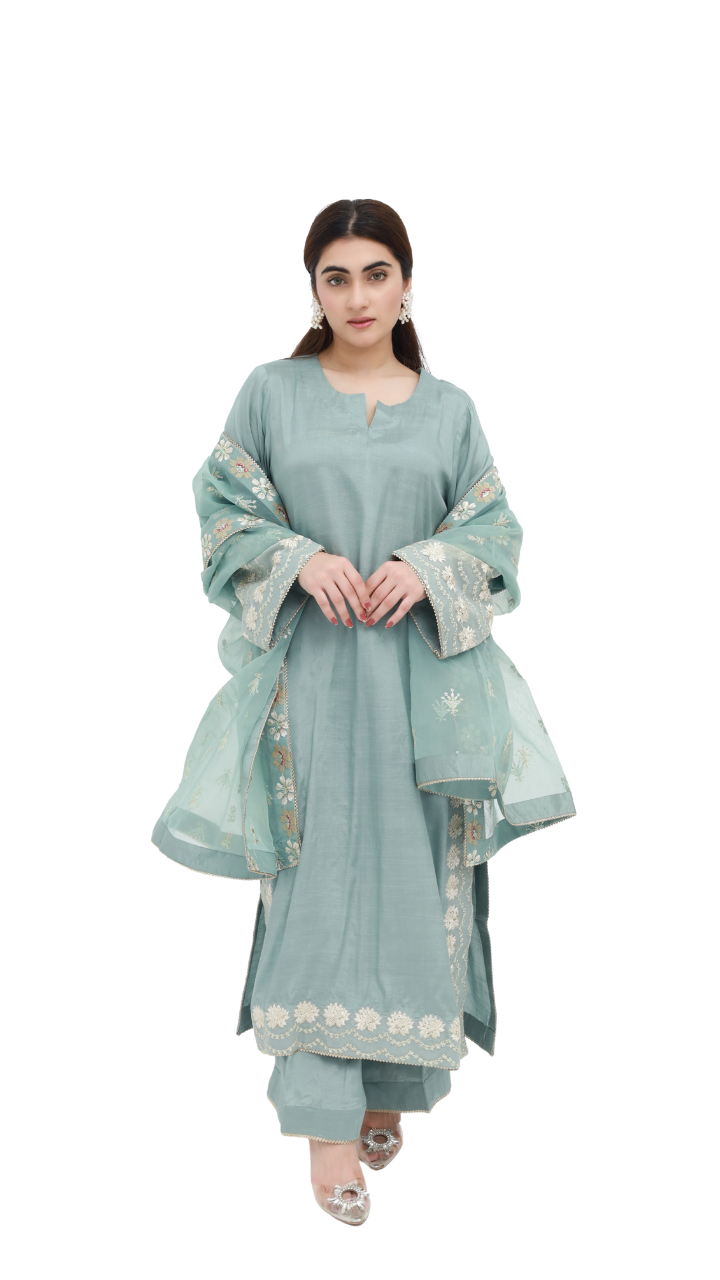 Daiselle-Woman wearing a light blue traditional outfit with white embroidery on a white background